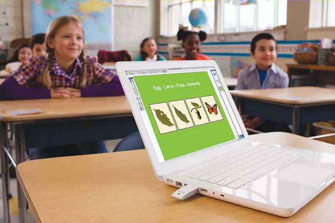 MimioStudio on a laptop with a class in the background